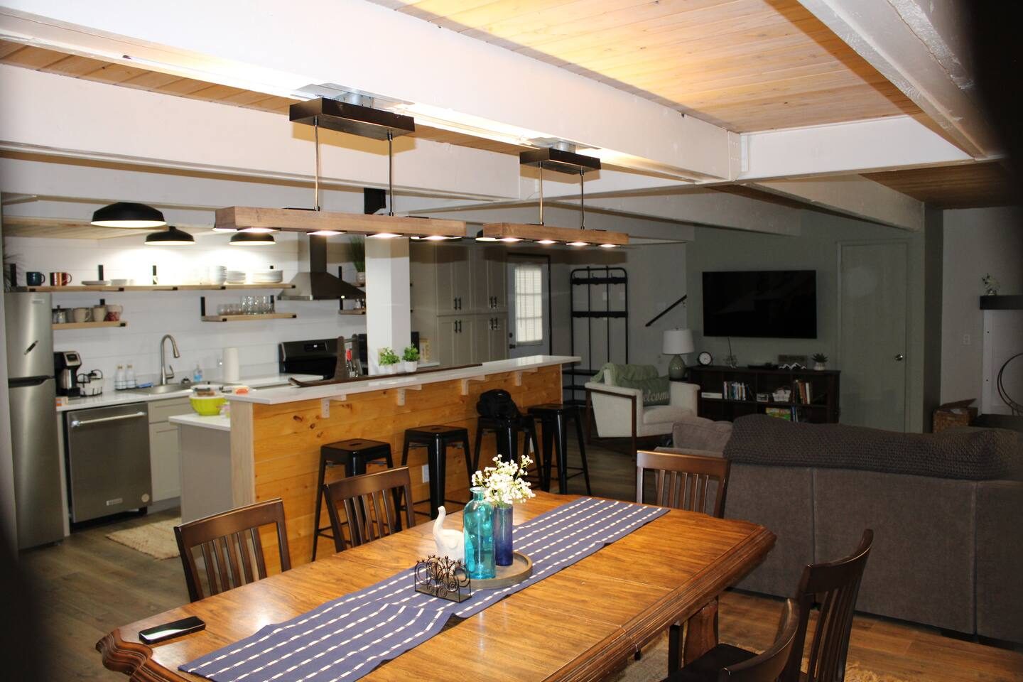 Open-concept kitchen, dining, and living area at Tall Timber