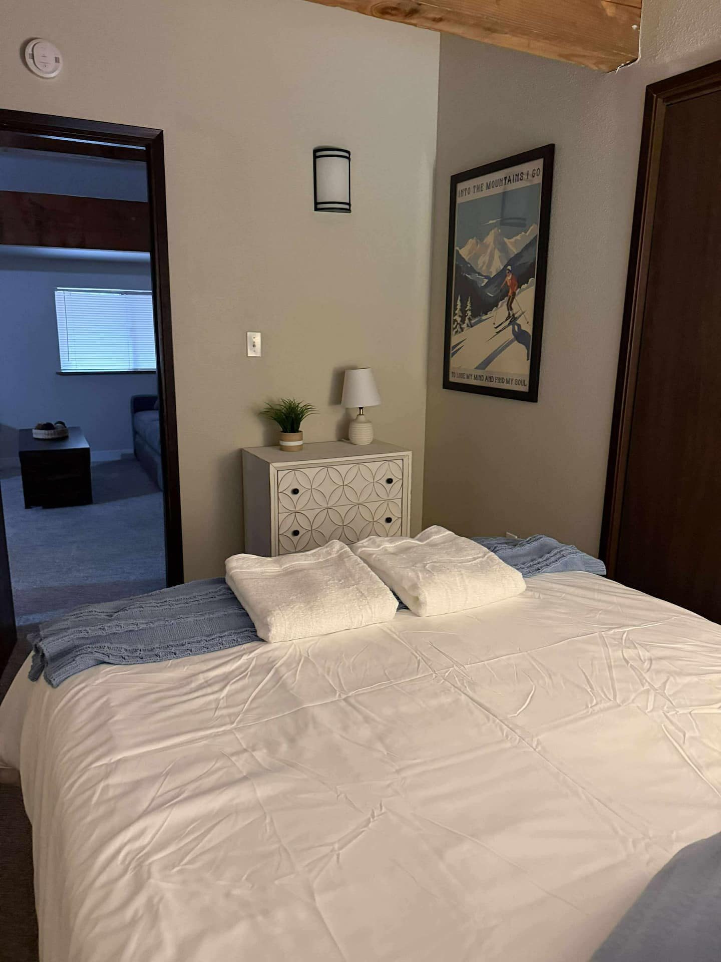 Queen bedroom with mountain artwork at Tall Timber