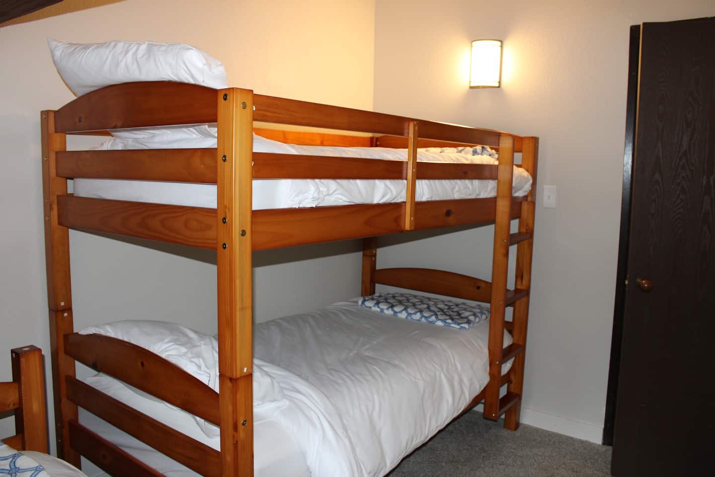 Bunk room with multiple beds at Tall Timber