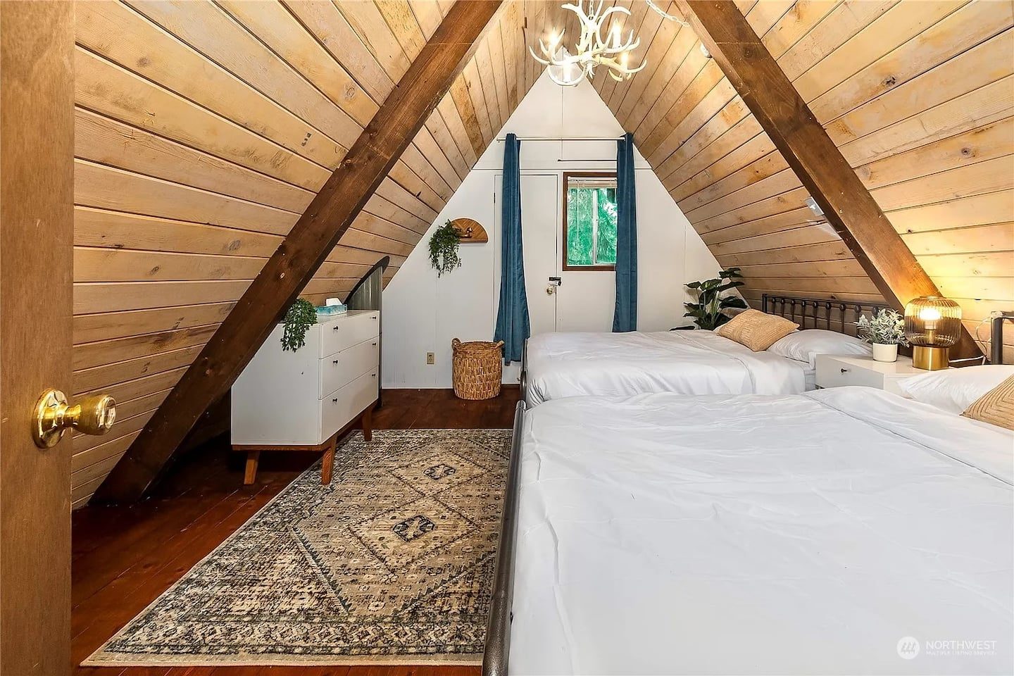 Sleeping loft under the A-frame peak at Tiny Timber