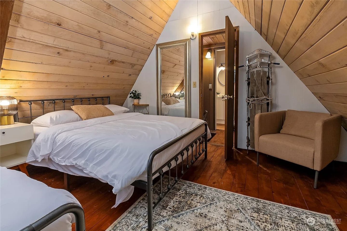 Bedroom tucked under the roofline at Tiny Timber